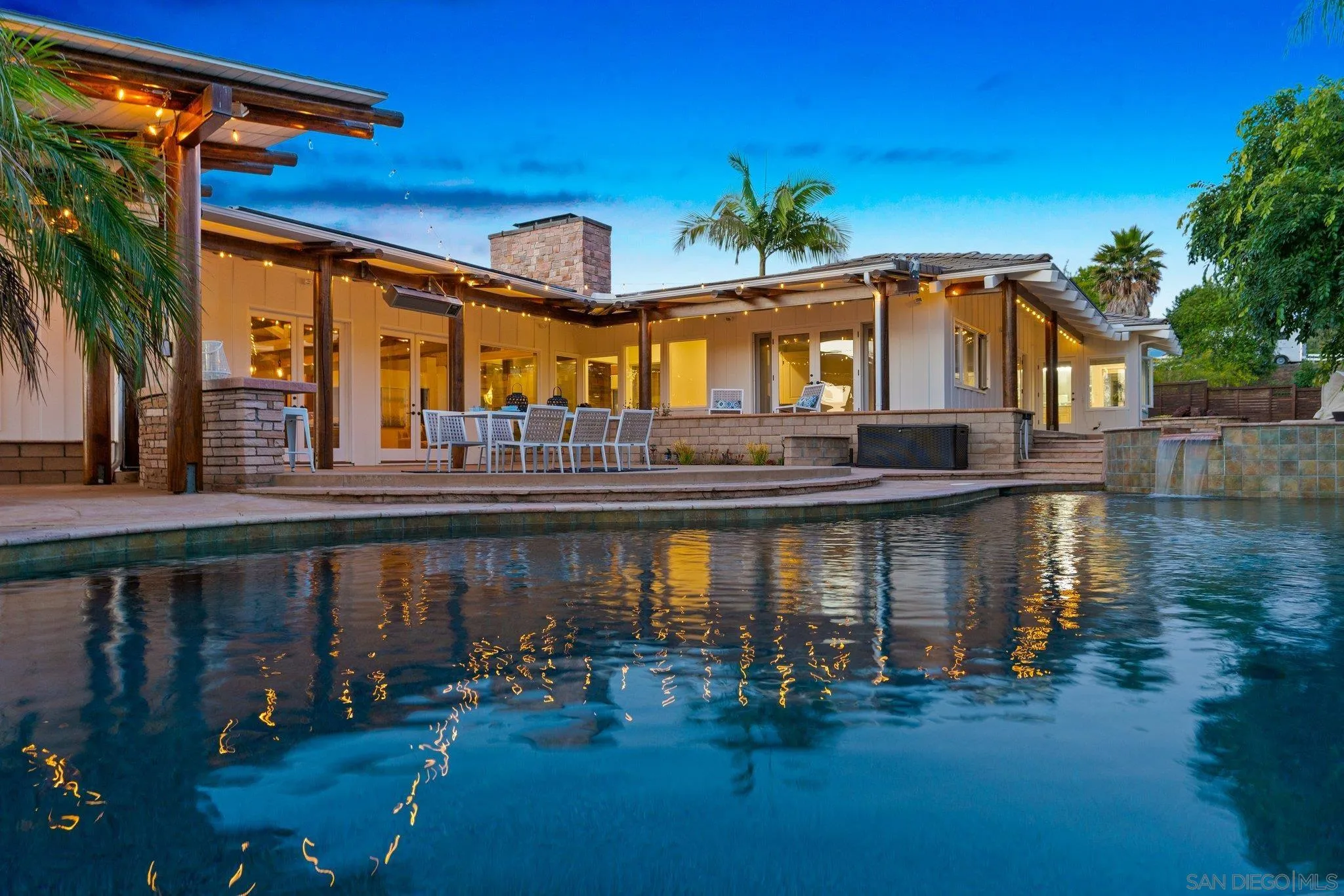 a front view of a house with swimming pool and glass windows