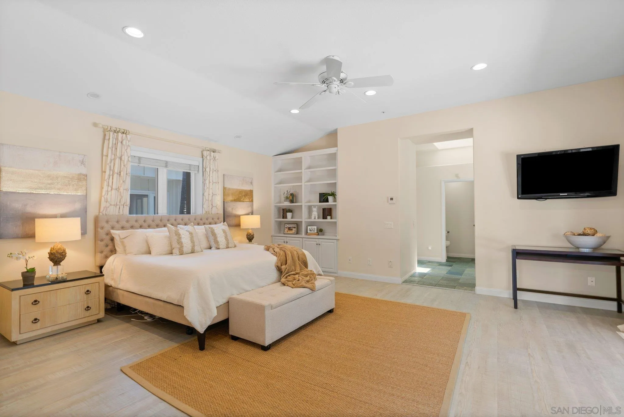 3111 Brookside Lane Encinitas, CA 92024 - Photo 12 of 40 a spacious bedroom with a bed and a flat screen television