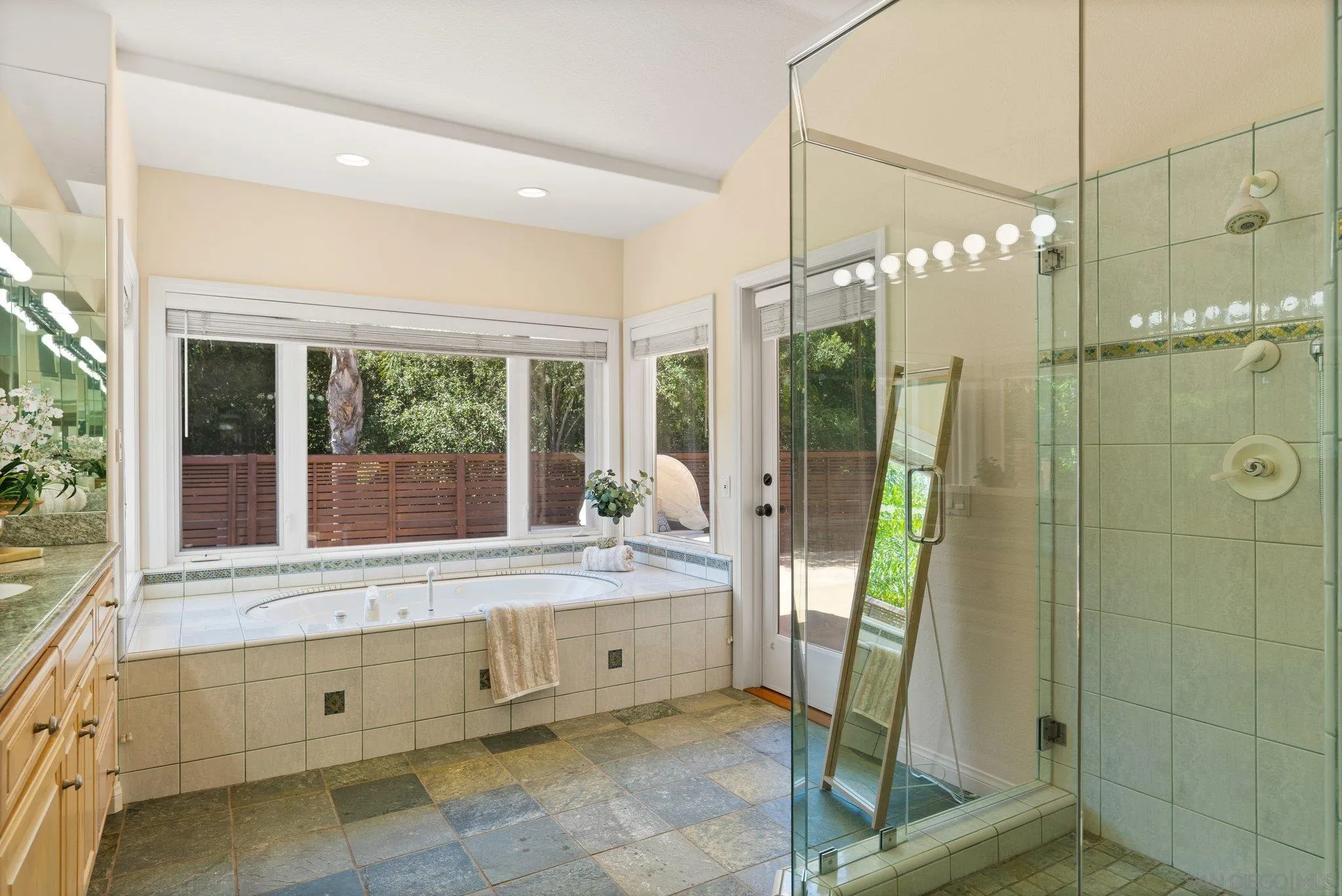3111 Brookside Lane Encinitas, CA 92024 - Photo 15 of 40 a bathroom with a double vanity sink and a large mirror