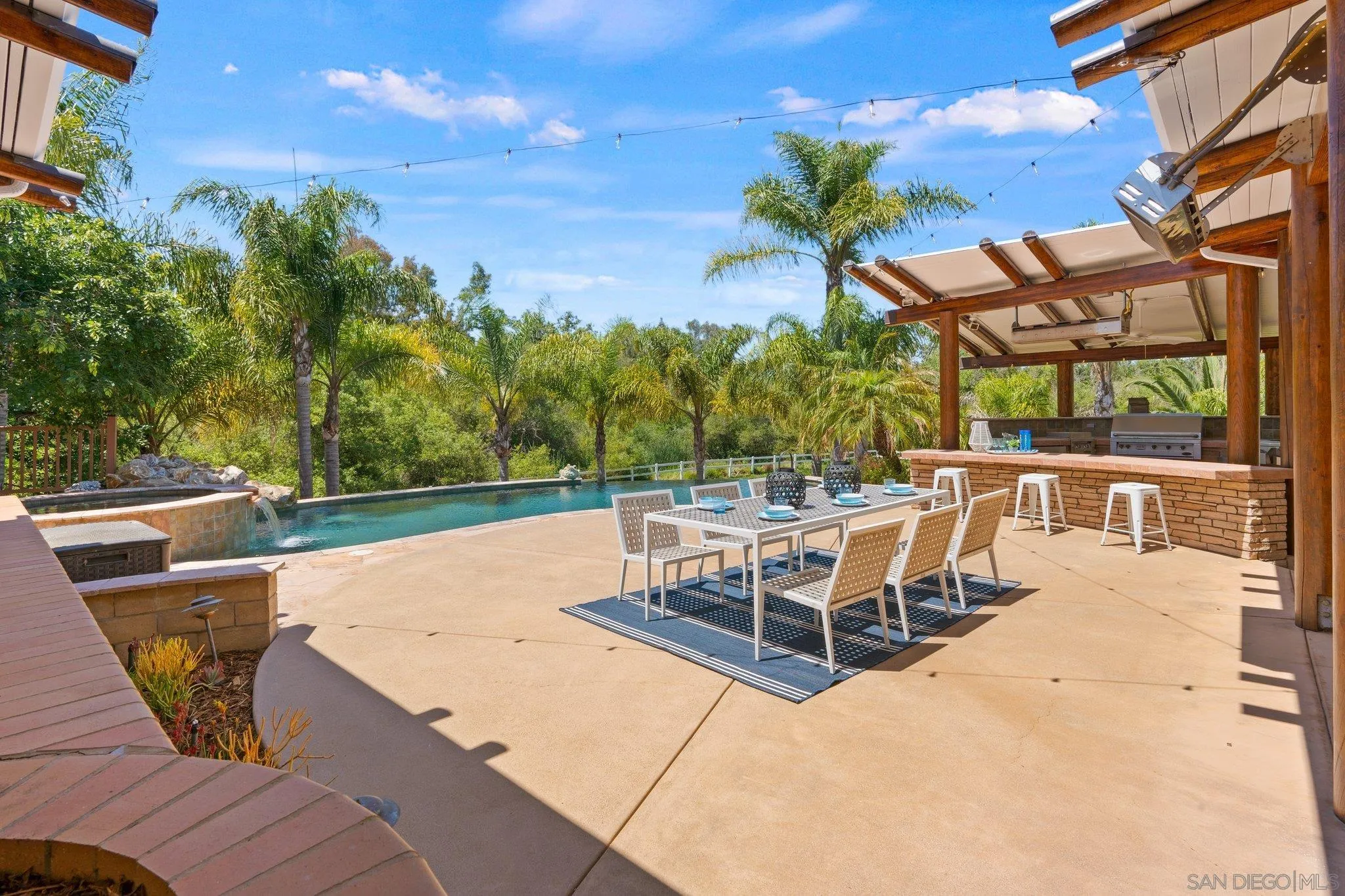 3111 Brookside Lane Encinitas, CA 92024 - Photo 19 of 40 a view of a patio with a table and chairs