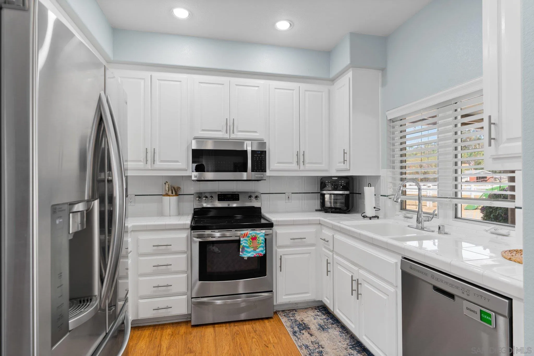 3111 Brookside Lane Encinitas, CA 92024 - Photo 33 of 40 a kitchen with stainless steel appliances a stove a sink and a refrigerator