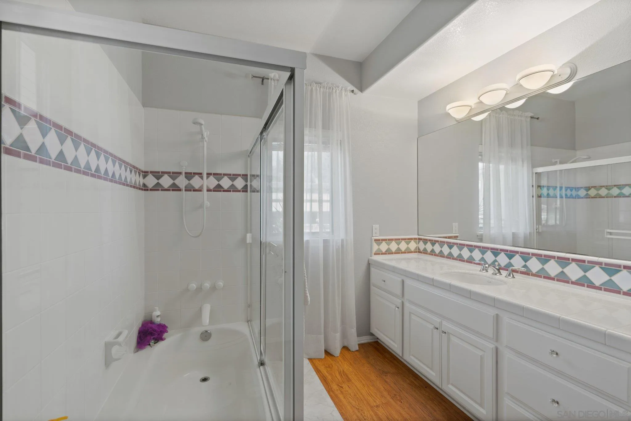 3111 Brookside Lane Encinitas, CA 92024 - Photo 34 of 40 a bathroom with a tub sink vanity and mirror