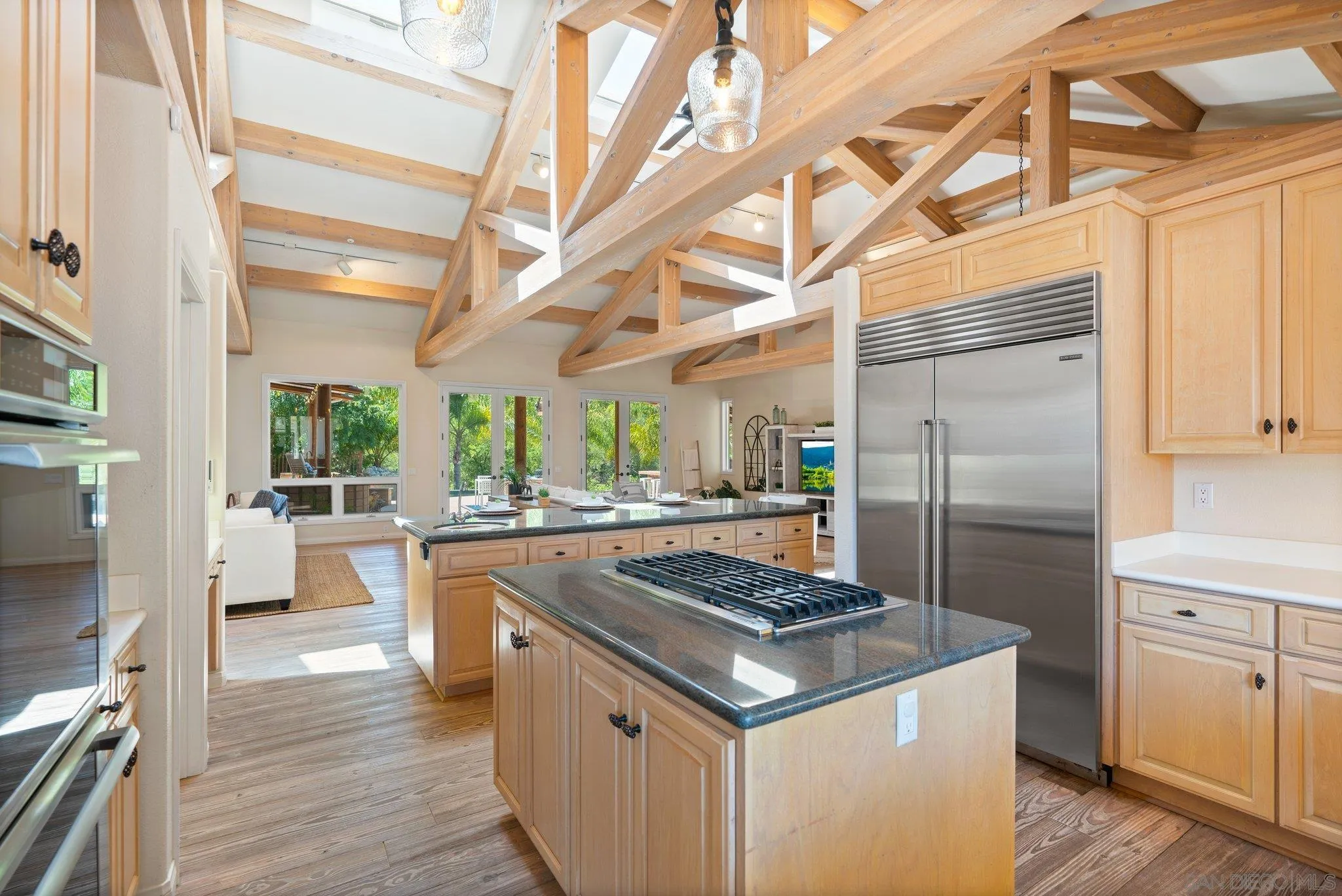 3111 Brookside Lane Encinitas, CA 92024 - Photo 10 of 40 a kitchen with a stove a refrigerator and wooden floor