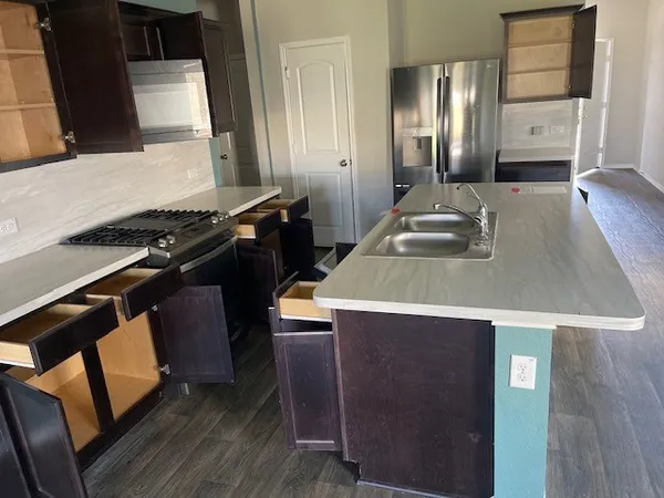 a kitchen that has a sink and a stove