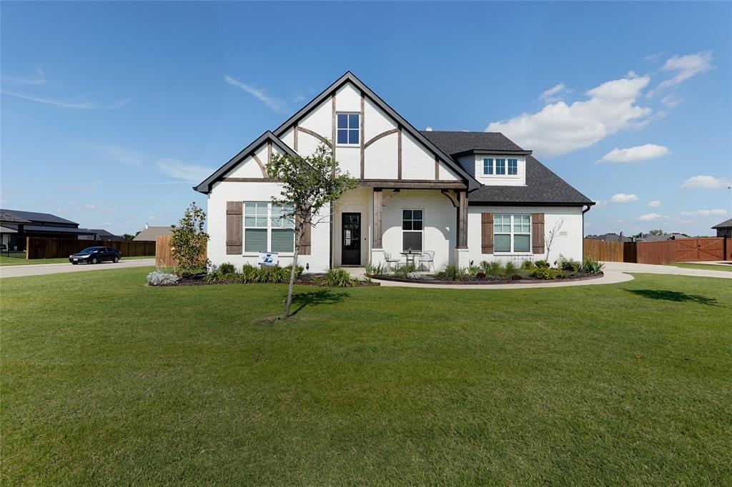 a front view of a house with a yard porch and outdoor seating
