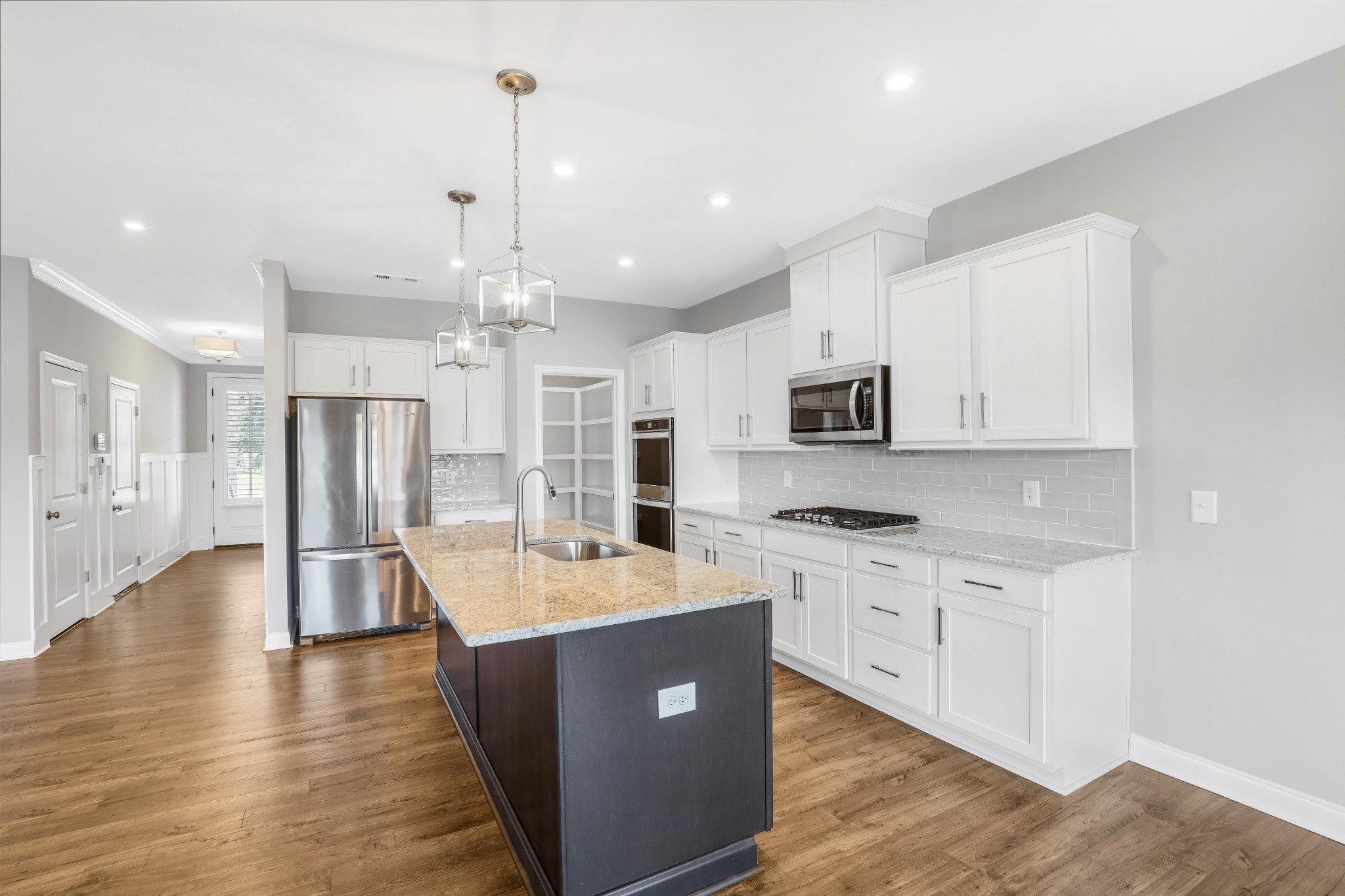 413 Meandering Way White House, TN 37188 - Photo 7 of 24 a large kitchen with stainless steel appliances kitchen island granite countertop a stove oven and a refrigerator