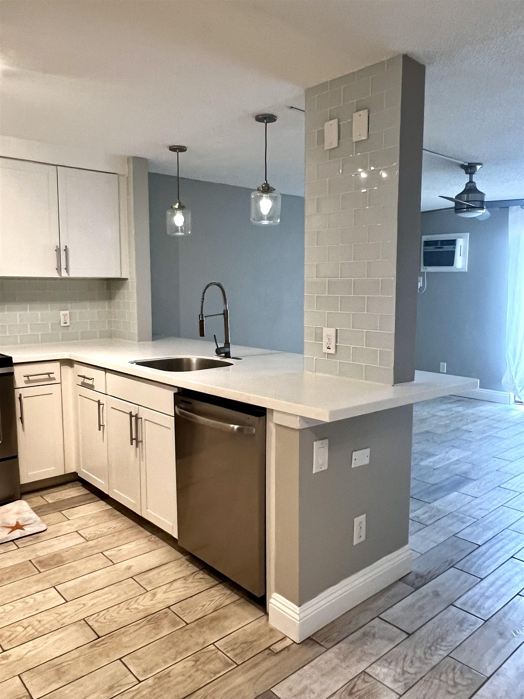 2747 South Kihei Road, Unit B101 Kihei, HI 96753 - Photo 1 of 38 a kitchen with a sink cabinets and wooden floor