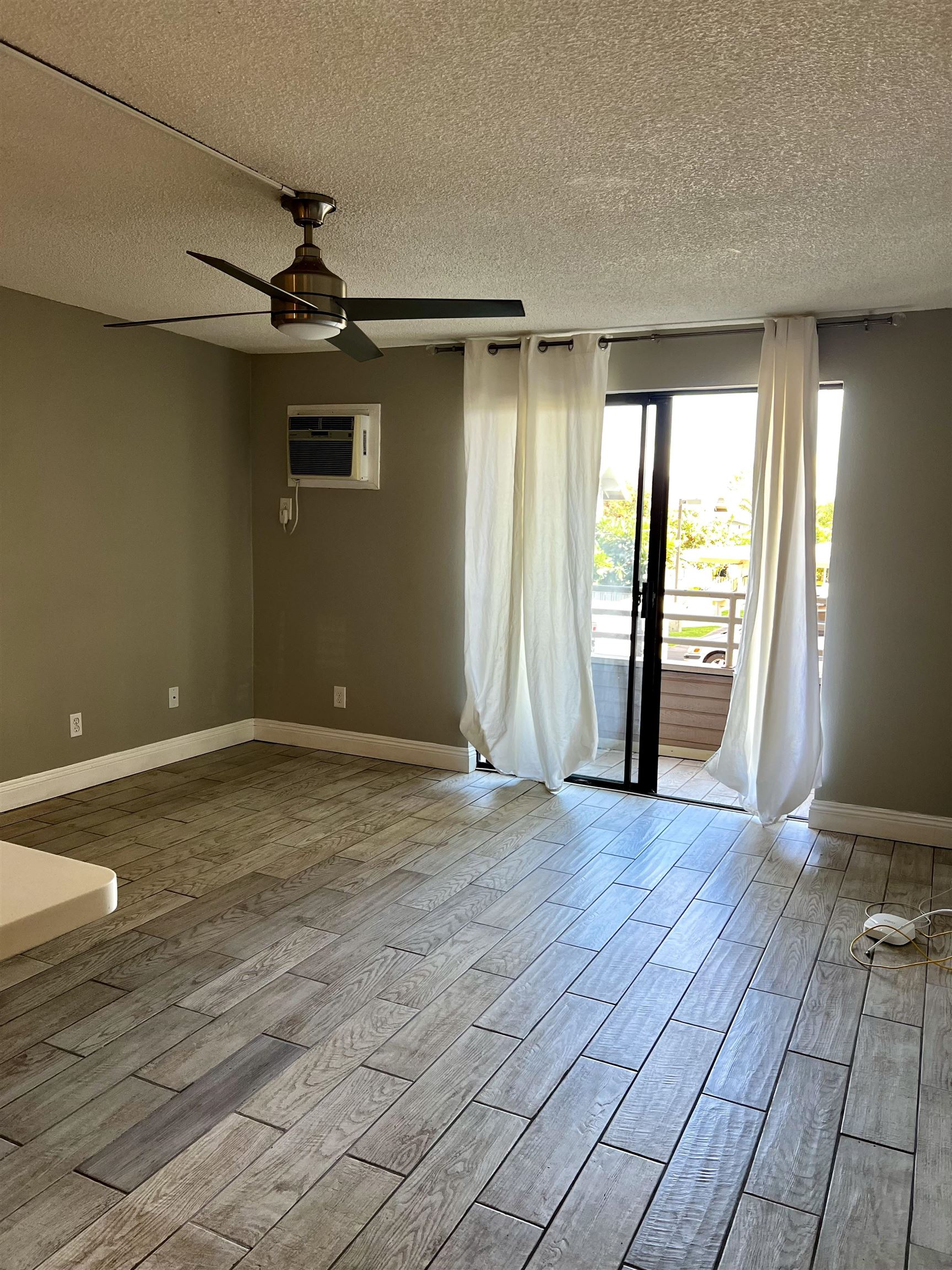 2747 South Kihei Road, Unit B101 Kihei, HI 96753 - Photo 14 of 38 an empty room with wooden floor and windows