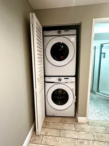 a view of a hallway with washer and dryer
