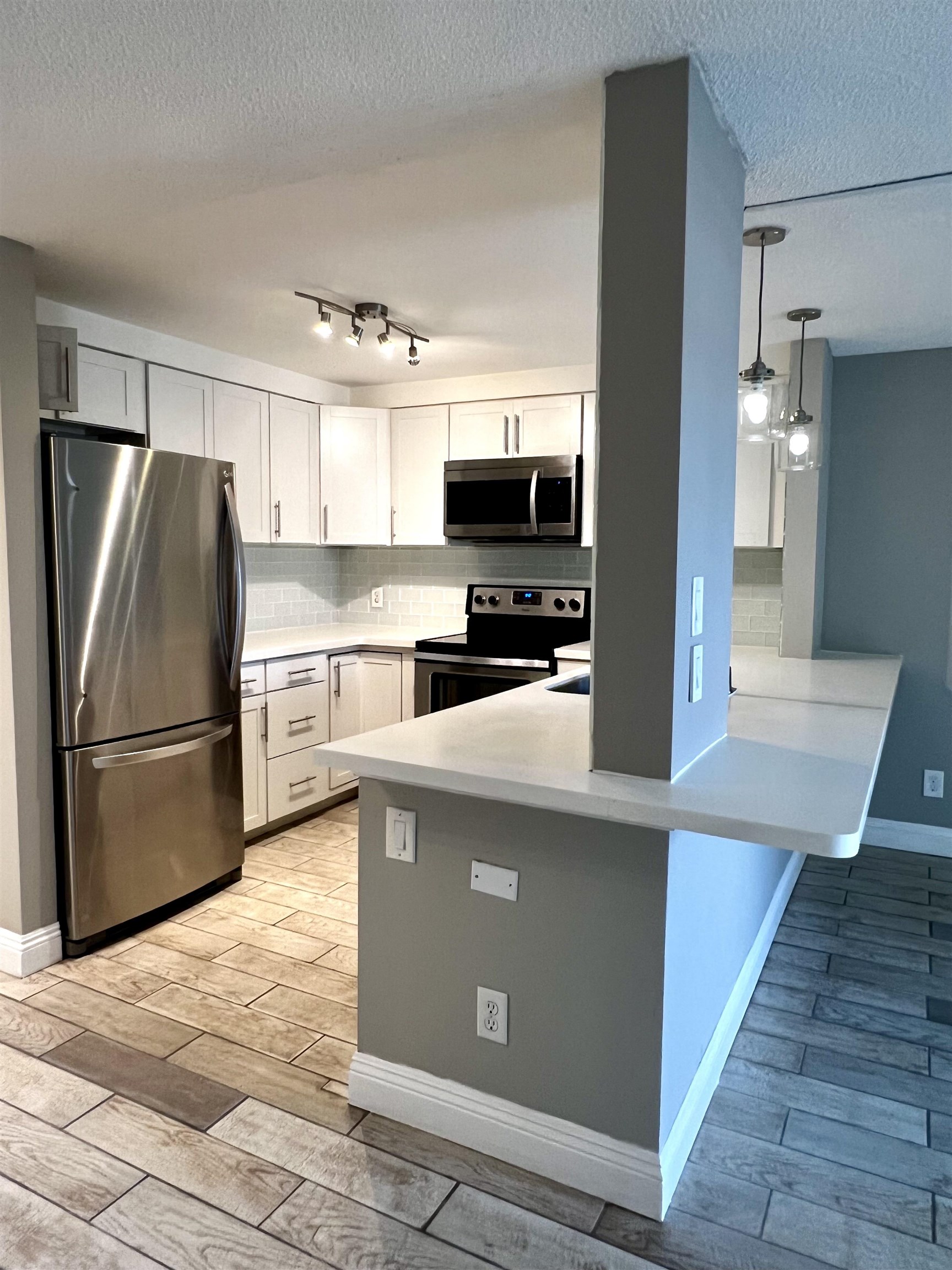 2747 South Kihei Road, Unit B101 Kihei, HI 96753 - Photo 3 of 38 a kitchen with stainless steel appliances a refrigerator and a stove top oven