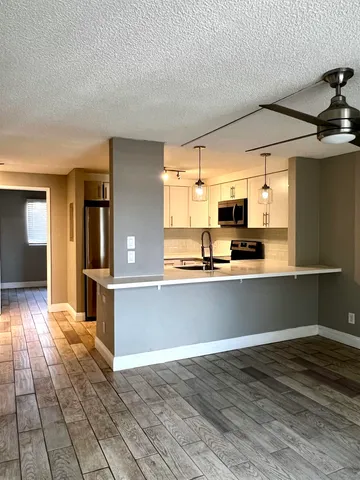 a kitchen with stainless steel appliances a refrigerator and microwave