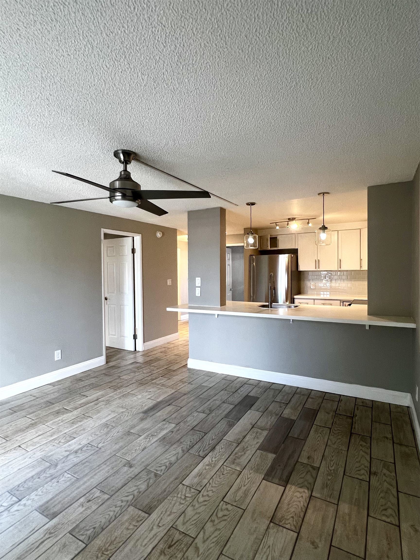2747 South Kihei Road, Unit B101 Kihei, HI 96753 - Photo 9 of 38 a view of an empty room with window and wooden floor