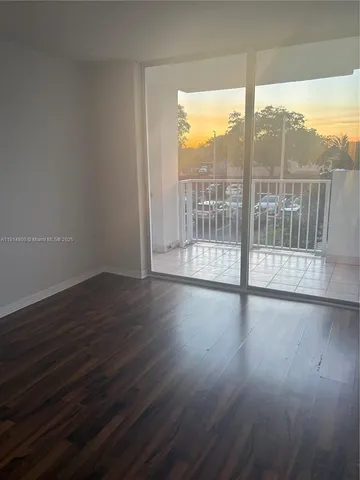a view of wooden floor and windows in a room