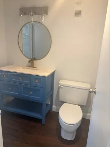 a bathroom with a toilet and a mirror