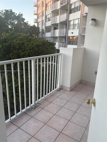 a view of a balcony with wooden fence