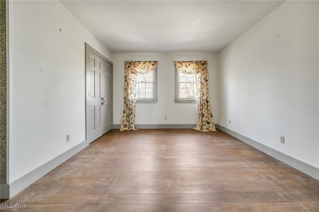 18060 Falling Leaves Road Strongsville, OH 44136 - Photo 32 of 43 Spare room featuring wood-type flooring and baseboards