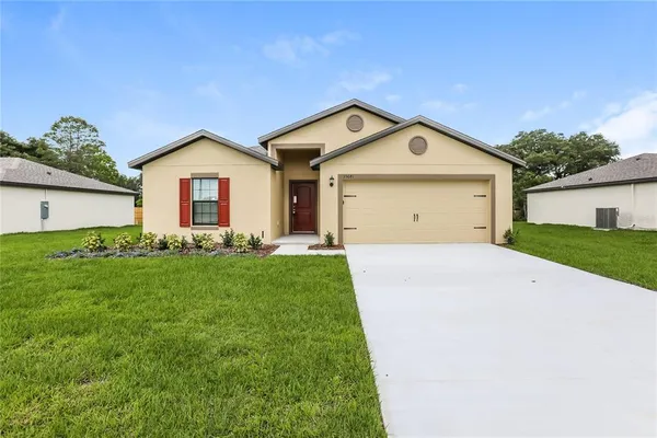 a front view of a house with a yard and garage