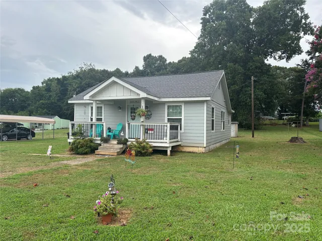 a view of a house with backyard porch and sitting area