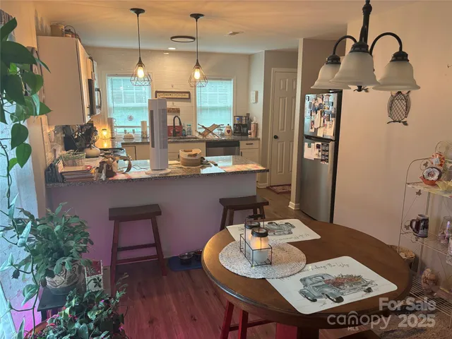 a dining room with furniture and wooden floor