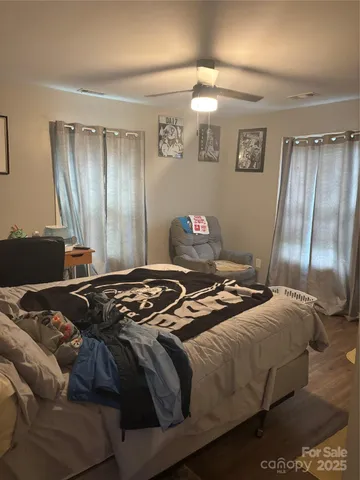 a bedroom with a bed and wooden floor