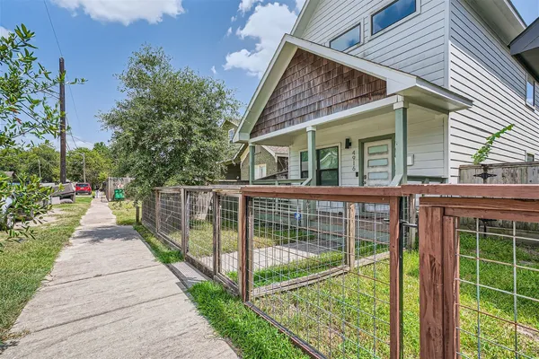 a view of a house with backyard and balcony