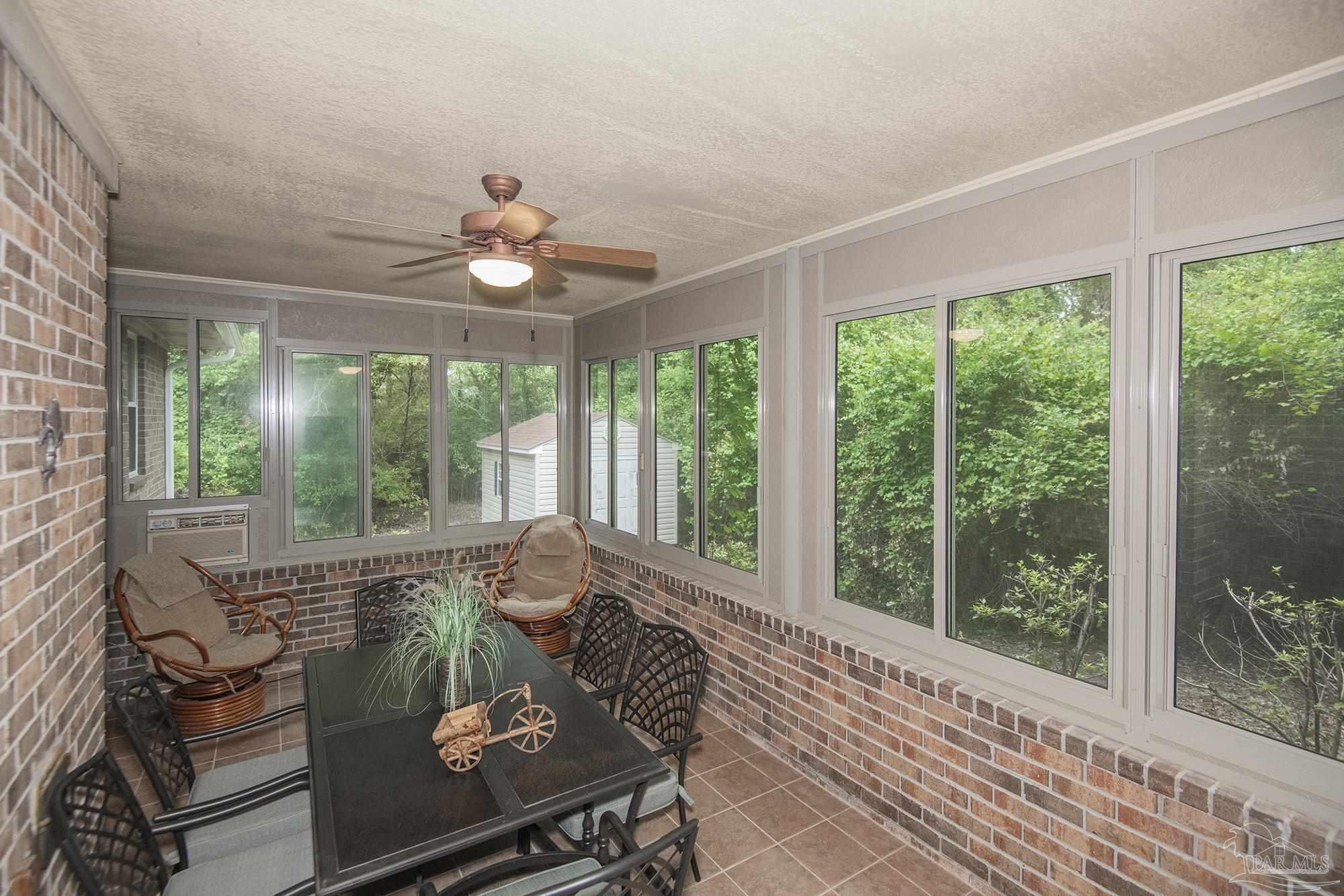 1210 Goldenrod Road Cantonment, FL 32533 - Photo 33 of 50 a living room with couch and a window