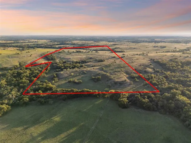 a view of an outdoor space with wooden floor and city view