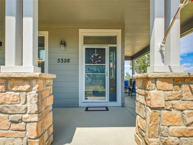 a dining room with furniture a chandelier and wooden floor