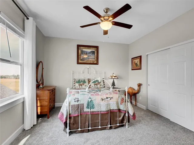 a spacious bedroom with a large bed and a dresser