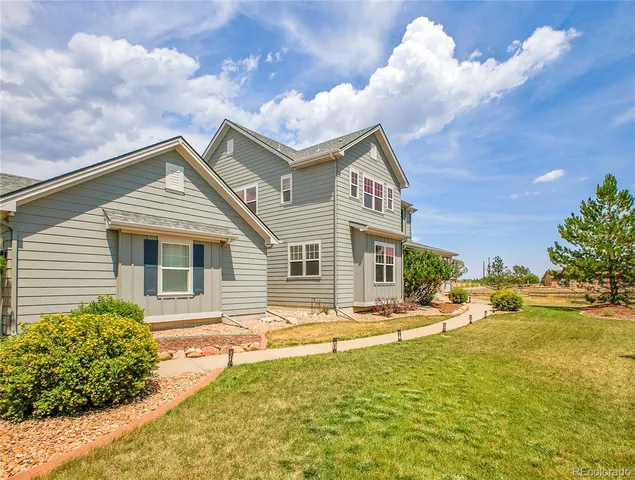 a view of a house with backyard and swimming pool