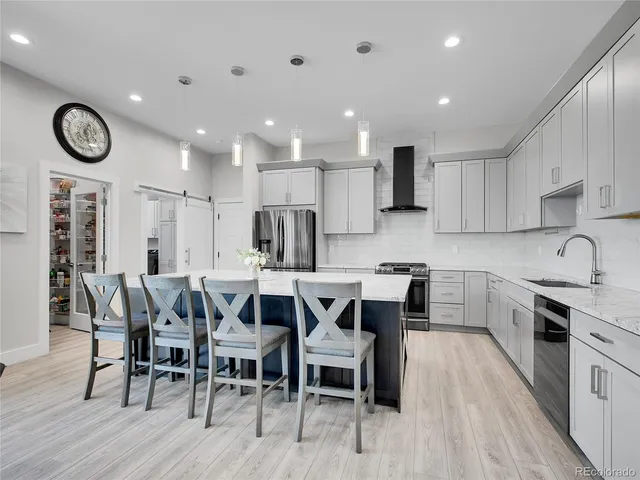 a large kitchen with a table and chairs