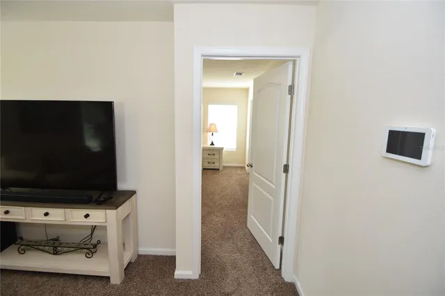 a view of a livingroom with furniture and a flat screen tv