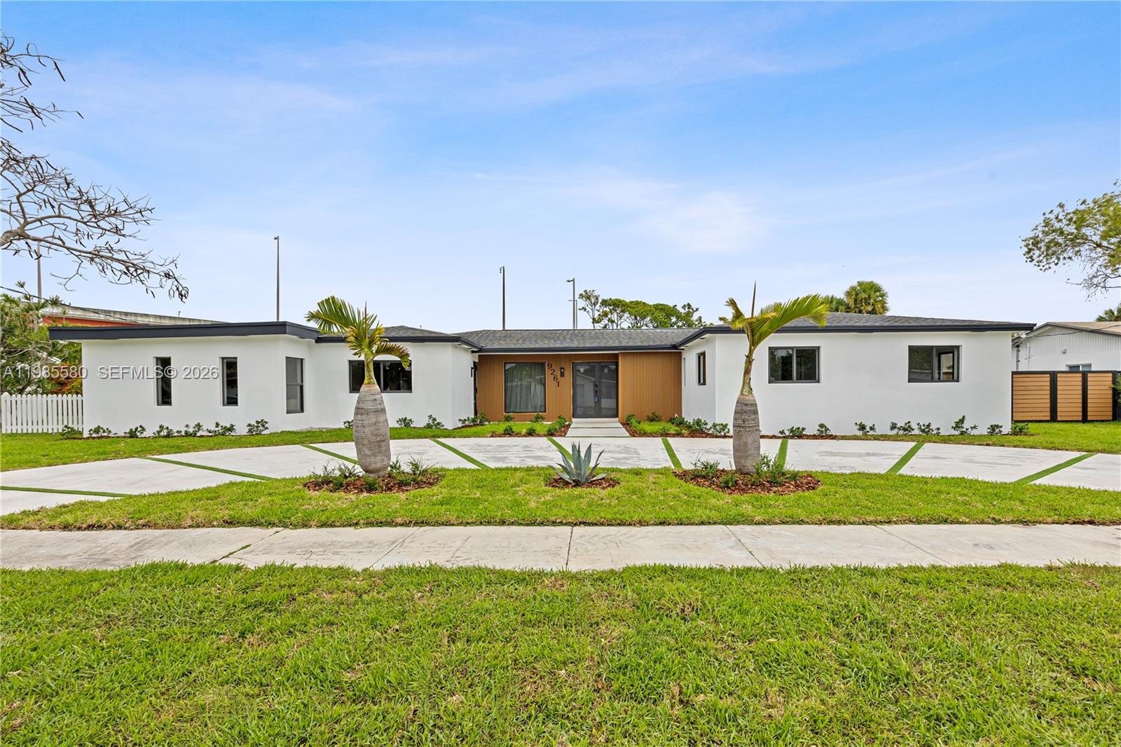 9261 Southwest 80th Terrace Miami, FL 33173 - Photo 2 of 58 a front view of a house with a yard and table and chairs