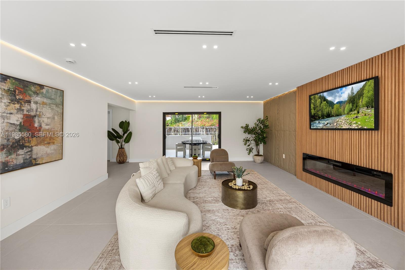 9261 Southwest 80th Terrace Miami, FL 33173 - Photo 21 of 58 a living room with furniture and a flat screen tv