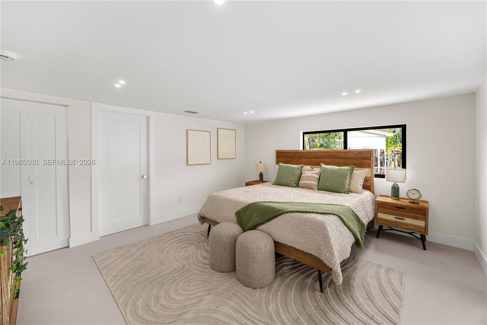 9261 Southwest 80th Terrace Miami, FL 33173 - Photo 30 of 58 a spacious bedroom with a bed and a lamp