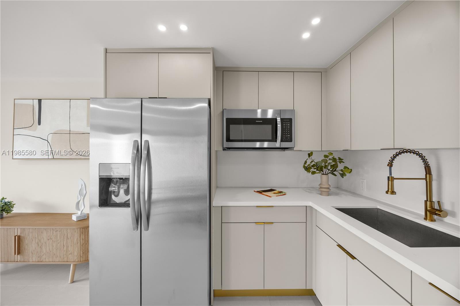 9261 Southwest 80th Terrace Miami, FL 33173 - Photo 39 of 58 a kitchen with a refrigerator sink and cabinets