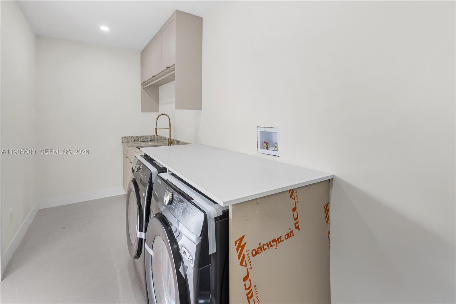 9261 Southwest 80th Terrace Miami, FL 33173 - Photo 50 of 58 a utility room with cabinets washer and dryer