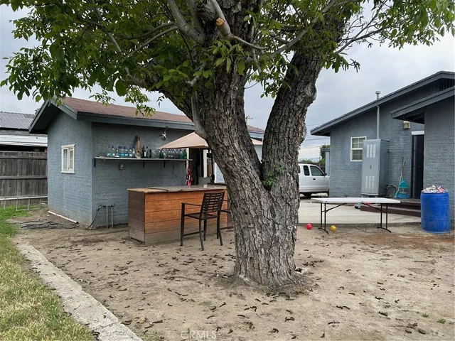 a view of a house with a yard and sitting area