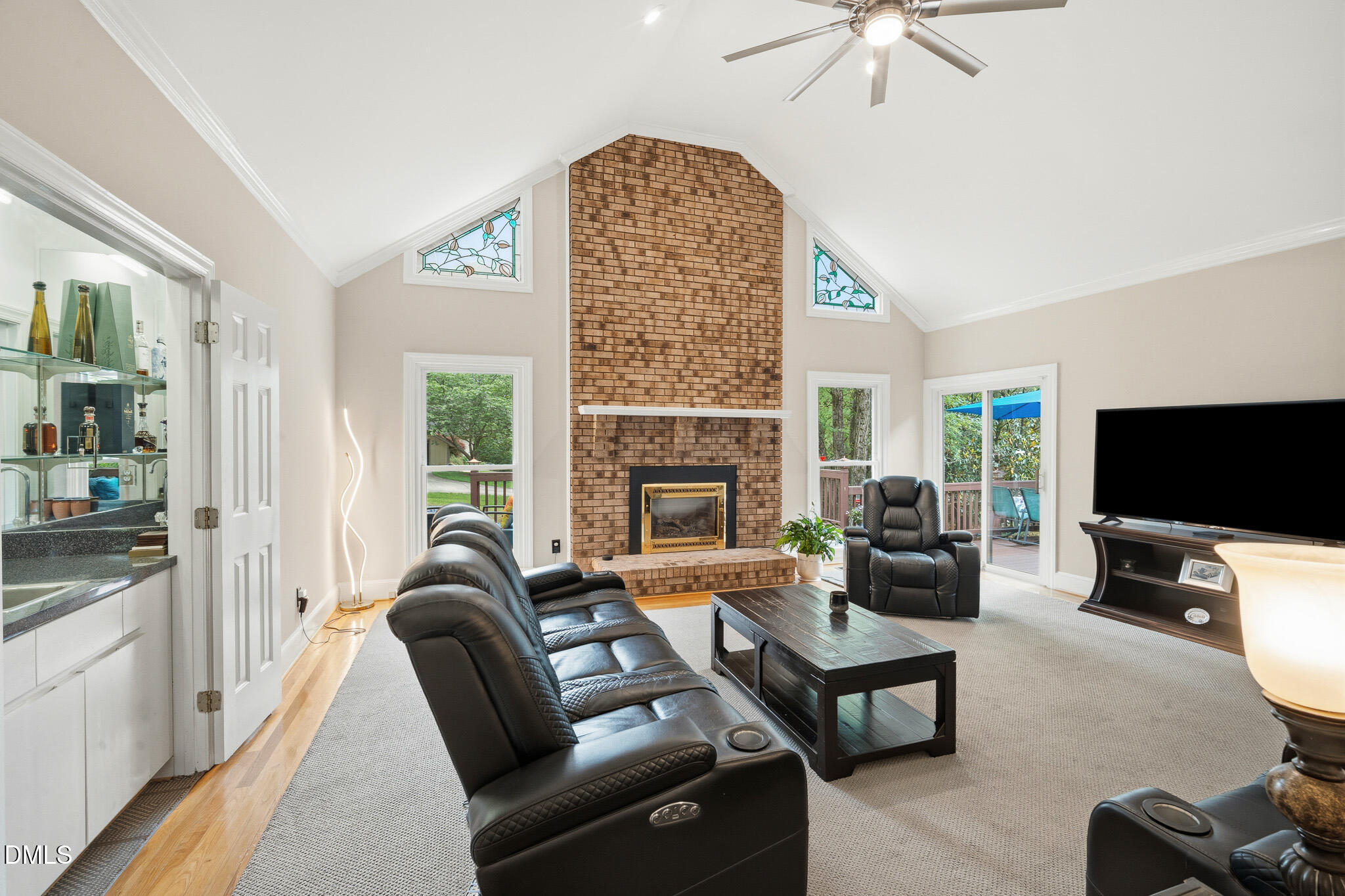 3735 Stoneybrook Drive Durham, NC 27705 - Photo 5 of 44 a living room with furniture a flat screen tv and a fireplace