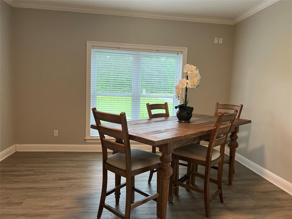 5270 Quad J Road Shreveport, LA 71107 - Photo 10 of 18 a view of a dining room with furniture and wooden floor