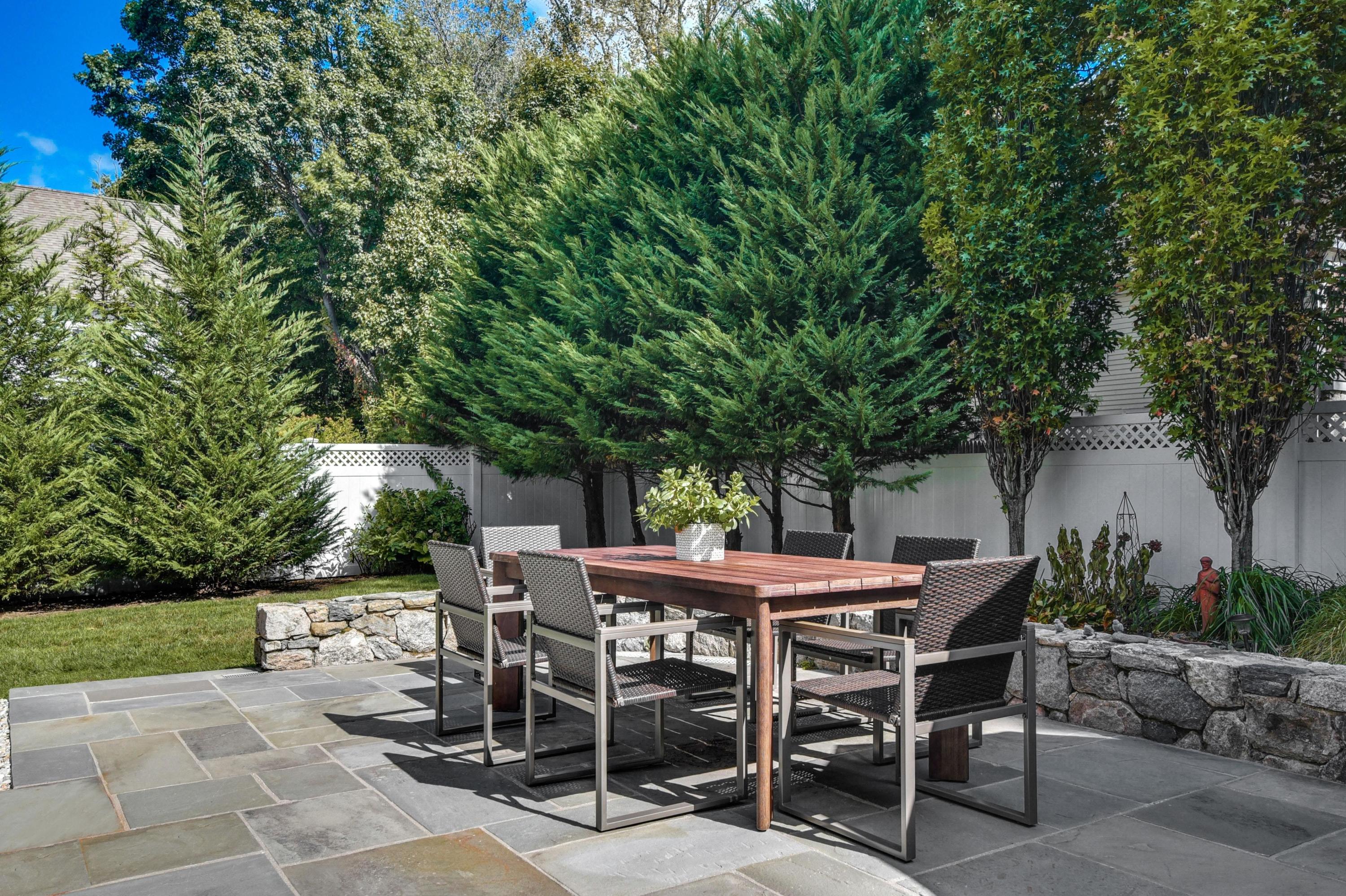 2269 Boston Post Road Darien, CT 06820 - Photo 22 of 39 a patio with table and chairs and potted plants