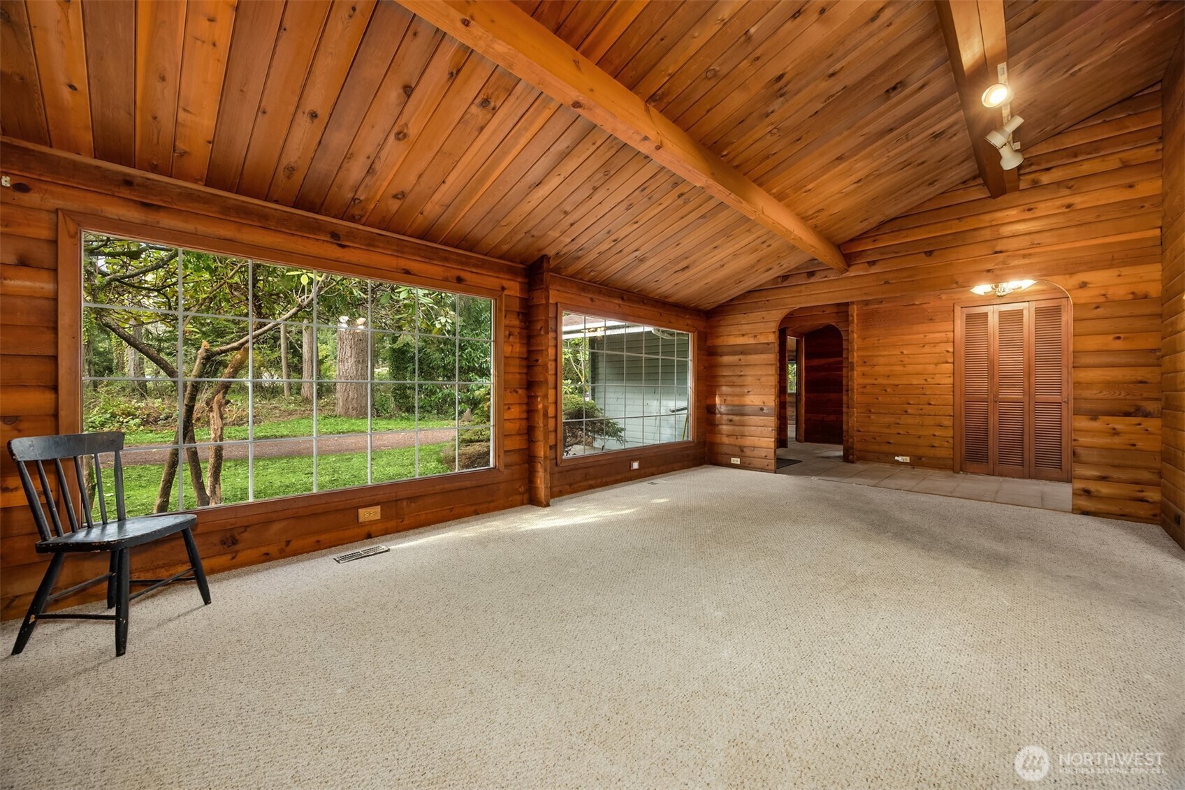 10862 Falk Road Northeast Bainbridge Island, WA 98110 - Photo 15 of 34 a view of a porch with furniture and floor to ceiling window