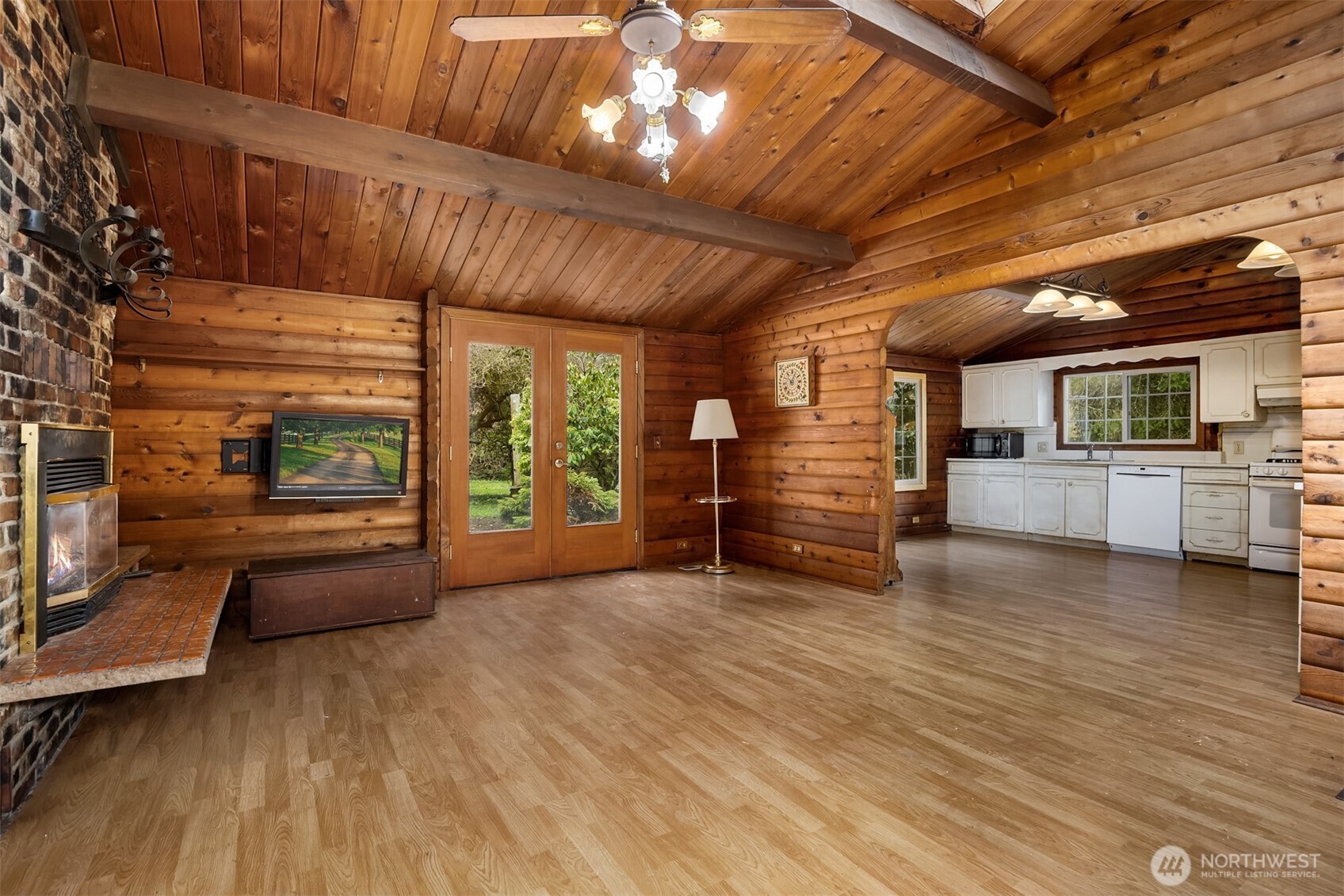 10862 Falk Road Northeast Bainbridge Island, WA 98110 - Photo 16 of 34 a view of an empty room with a fireplace and windows