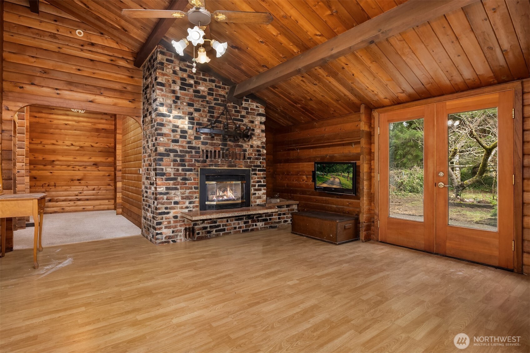 10862 Falk Road Northeast Bainbridge Island, WA 98110 - Photo 17 of 34 a view of an empty room with a fireplace and a window