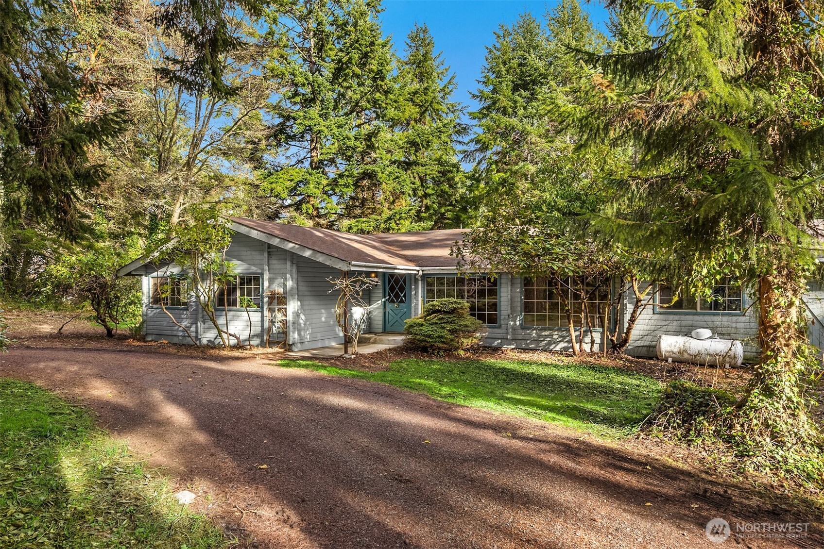 10862 Falk Road Northeast Bainbridge Island, WA 98110 - Photo 2 of 34 front view of a house with a yard