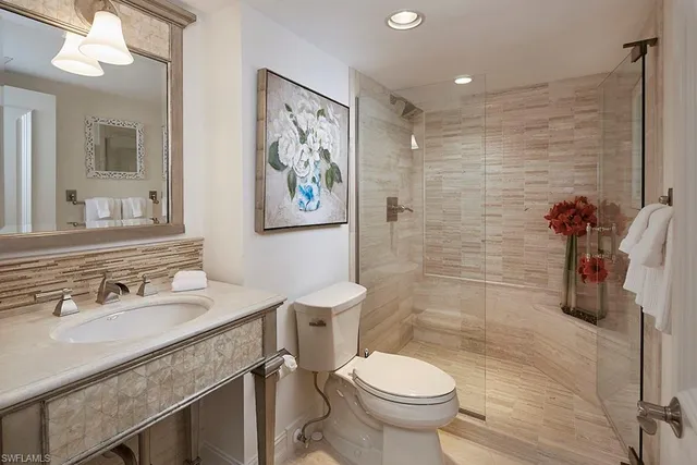 a bathroom with a sink mirror vanity and toilet