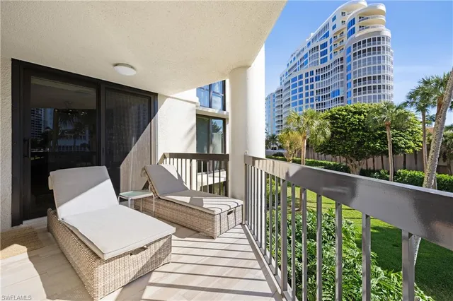 a view of balcony with wooden floor and outdoor seating