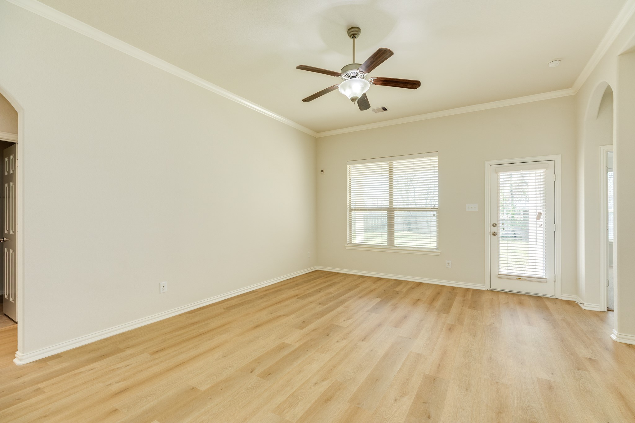 13417 Star Creek Lane Rosharon, TX 77583 - Photo 15 of 41 The family room features engineered wood flooring, which requires low maintenance. Oversized windows offer views of the backyard, and a back door provides exterior access. The entrance to the secondary bedrooms and bath is on th