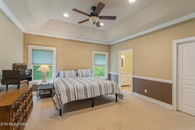 a spacious bedroom with a bed and a chandelier
