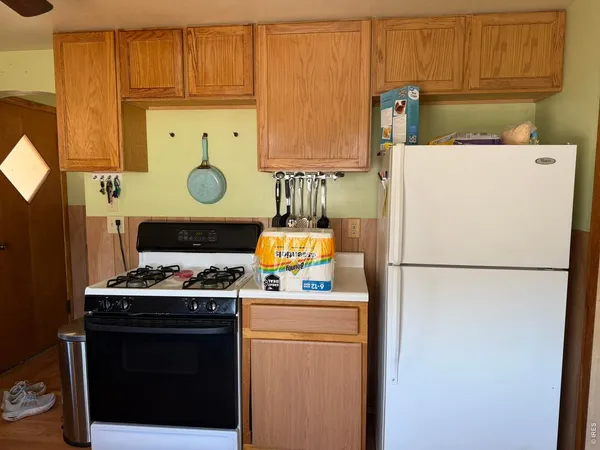 a white refrigerator freezer and a stove
